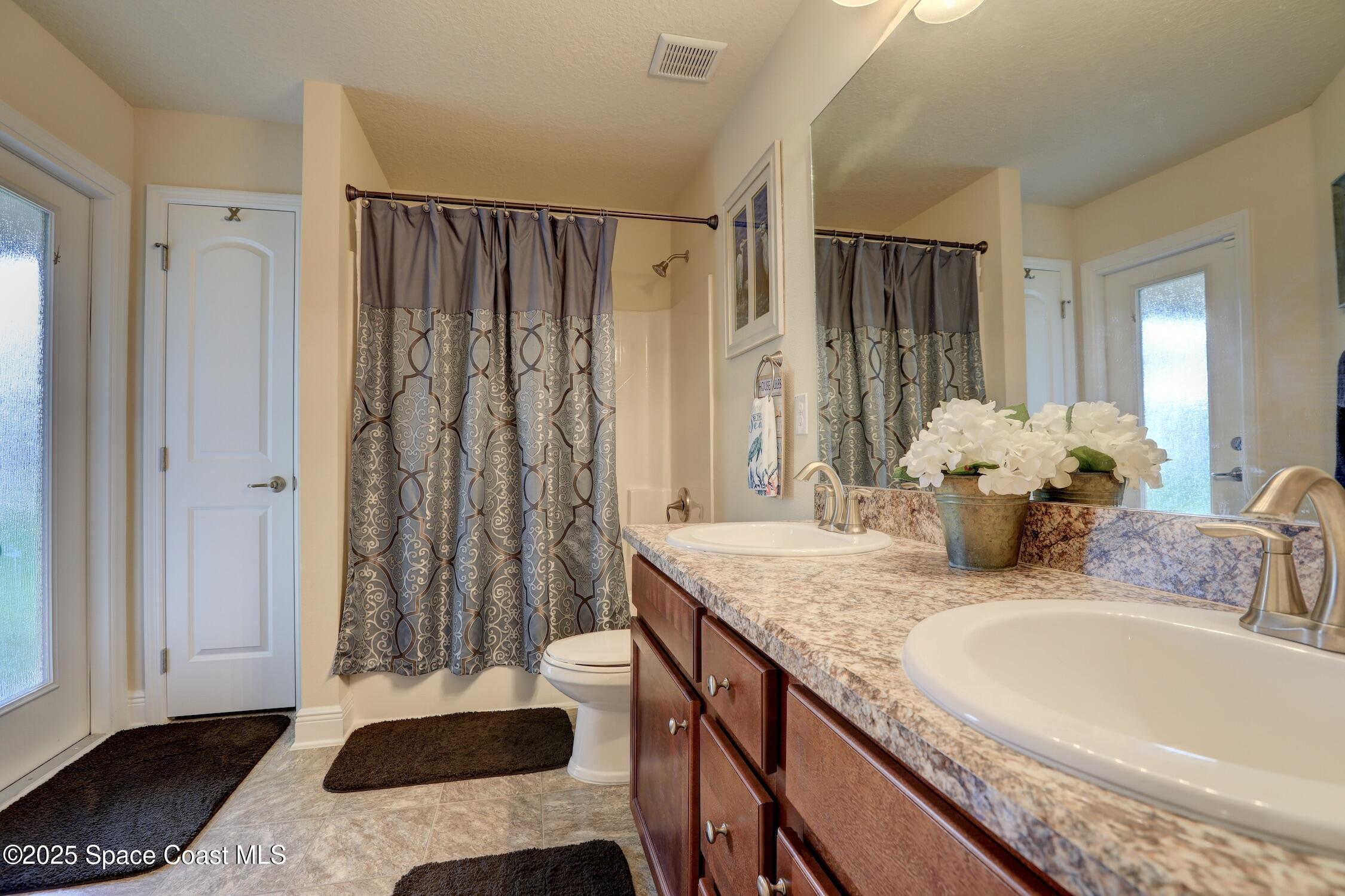 443 Lanfair Avenue Sebastian, FL 32958 - Photo 18 of 33 a bathroom with a granite countertop sink and a mirror