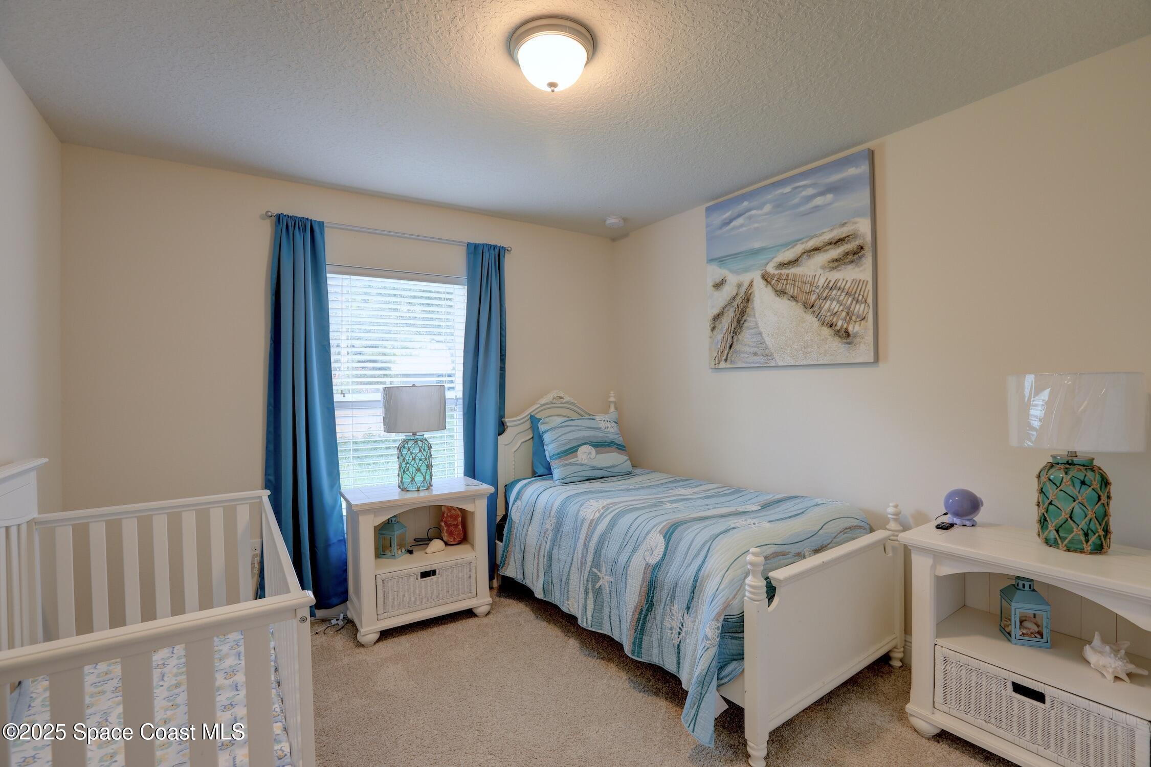 443 Lanfair Avenue Sebastian, FL 32958 - Photo 19 of 33 a bedroom with a bed and a window
