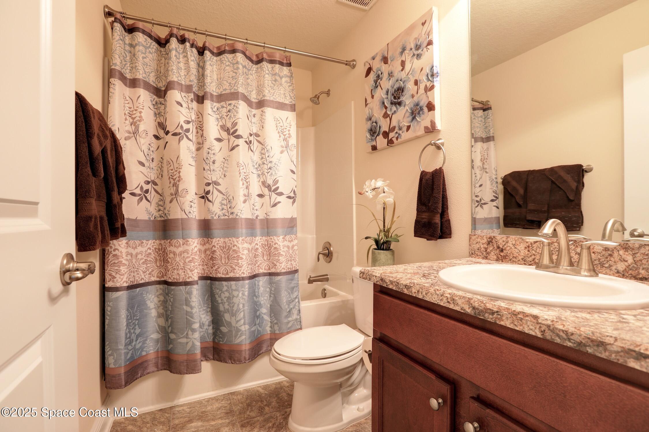 443 Lanfair Avenue Sebastian, FL 32958 - Photo 21 of 33 a bathroom with a granite countertop sink toilet mirror and shower