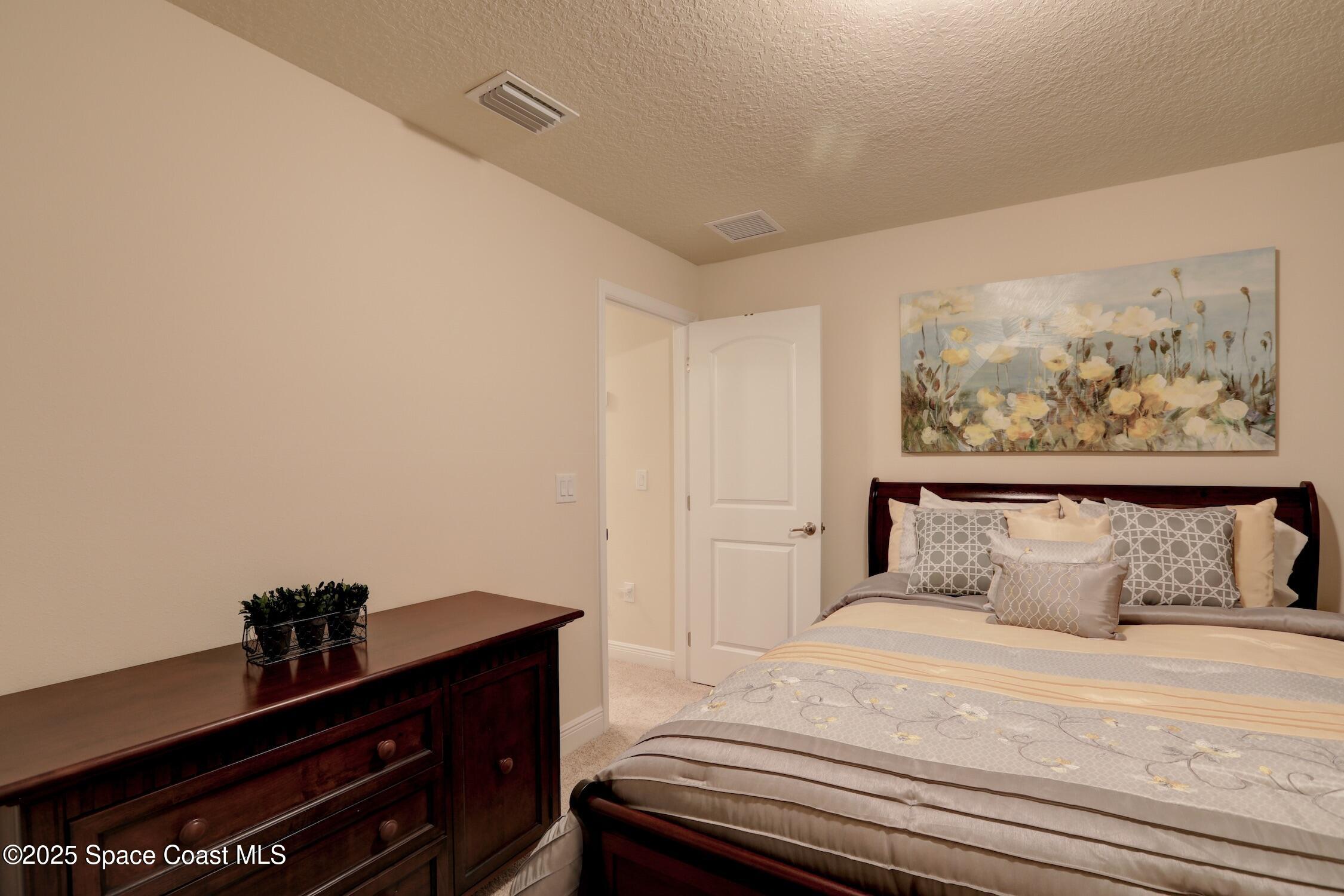 443 Lanfair Avenue Sebastian, FL 32958 - Photo 23 of 33 a bedroom with a bed and a window