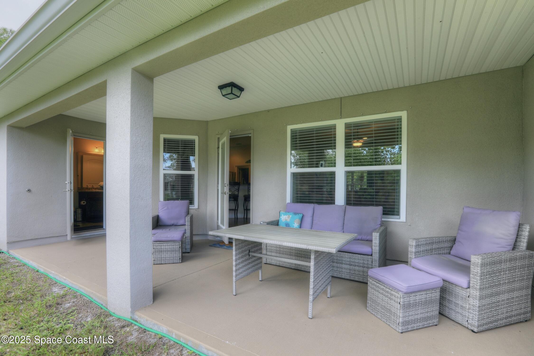 443 Lanfair Avenue Sebastian, FL 32958 - Photo 26 of 33 a outdoor living space with furniture and a rug