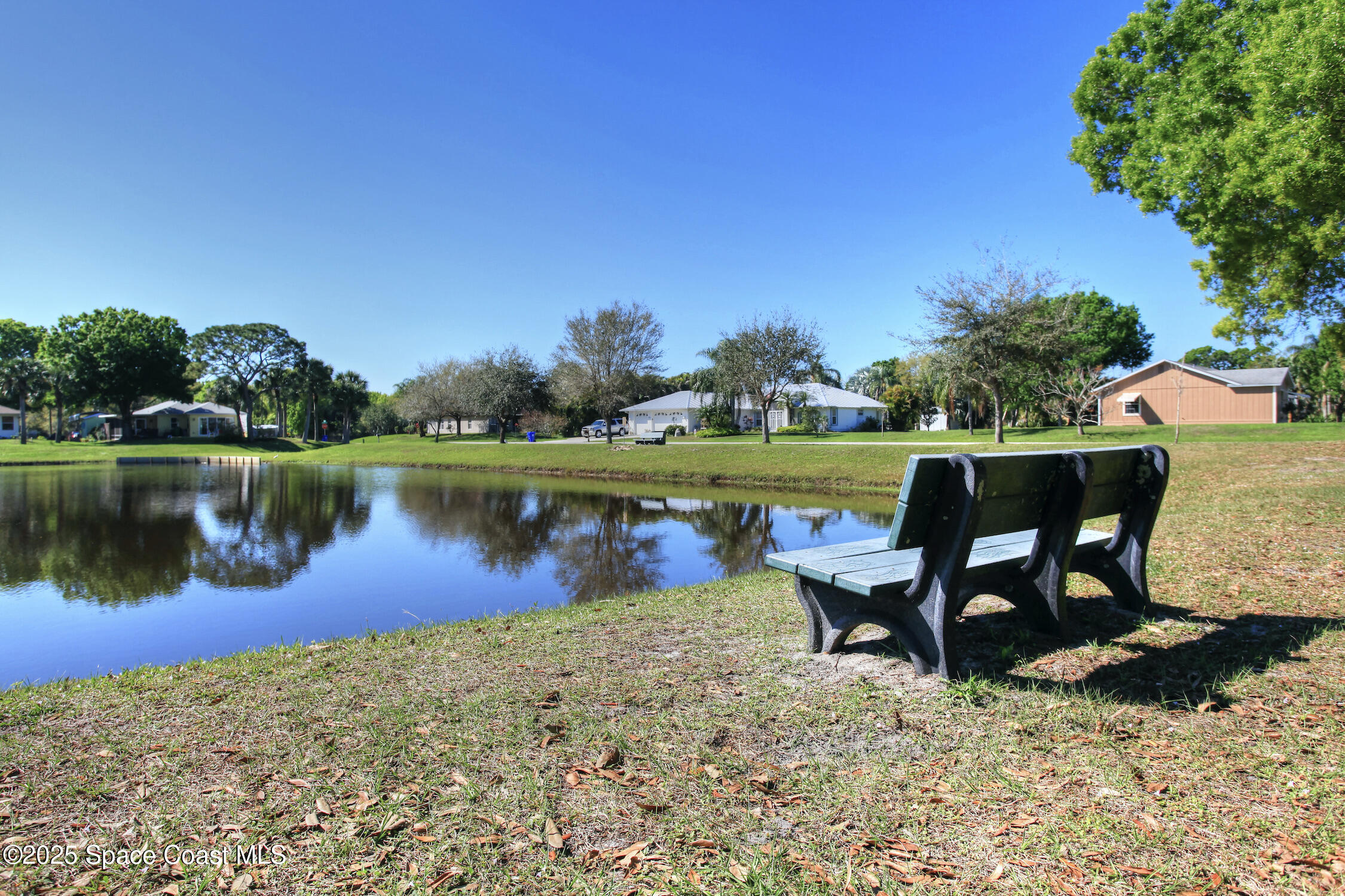 443 Lanfair Avenue Sebastian, FL 32958 - Photo 29 of 33 a view of a lake with a table and a lake view