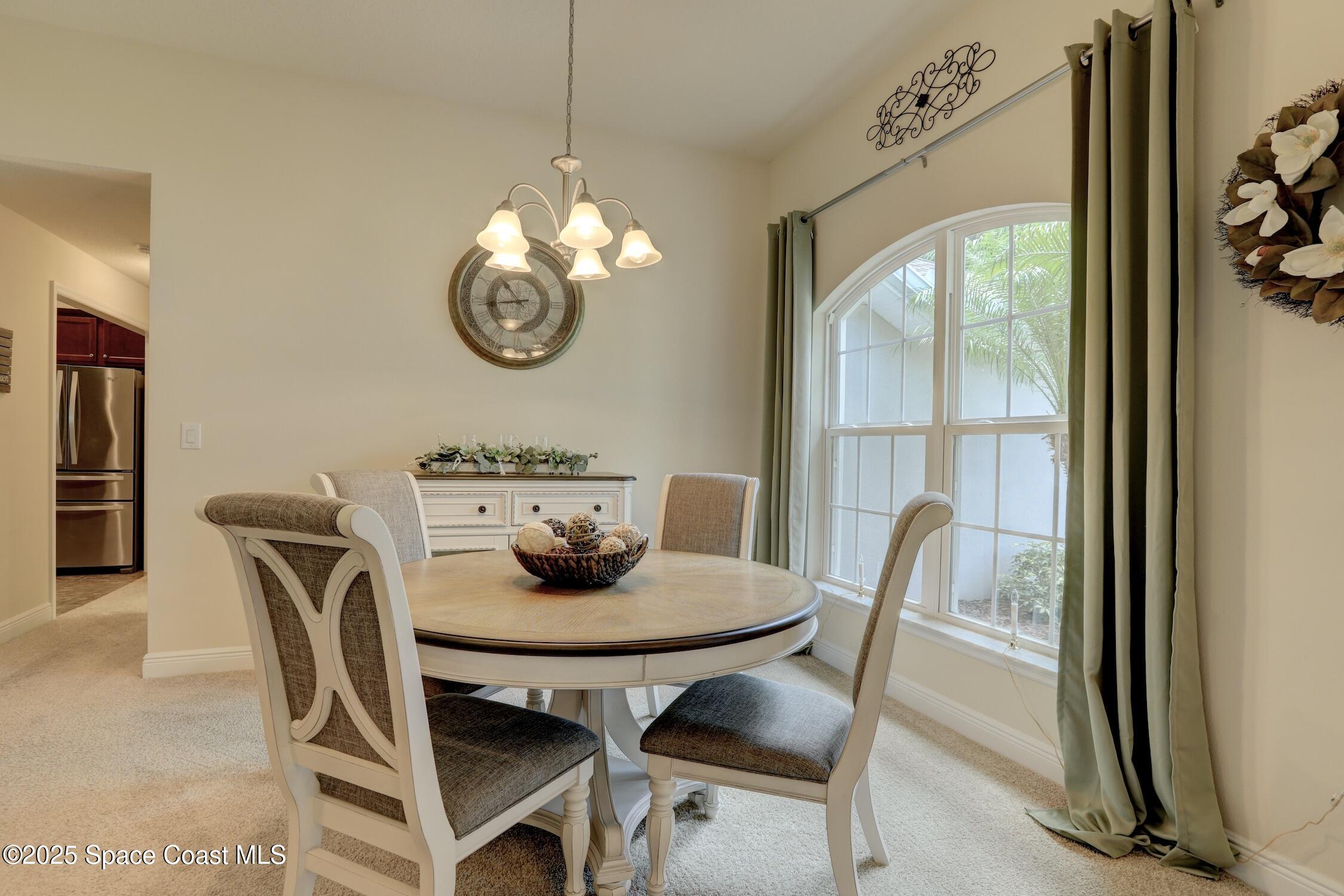 443 Lanfair Avenue Sebastian, FL 32958 - Photo 8 of 33 a dining room with furniture a rug and a mirror