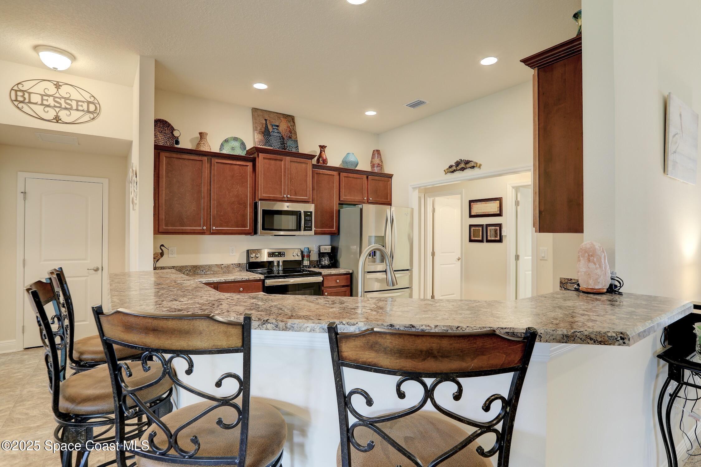 443 Lanfair Avenue Sebastian, FL 32958 - Photo 10 of 33 a kitchen with a dining table cabinets and appliances
