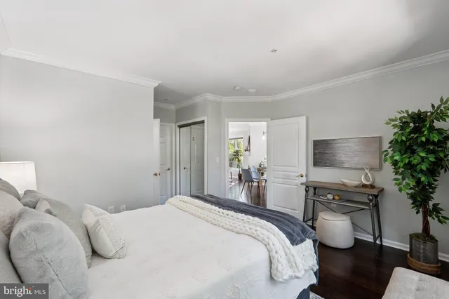 a bedroom with a bed and a potted plant