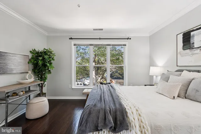 a bed sitting in a bedroom next to a window