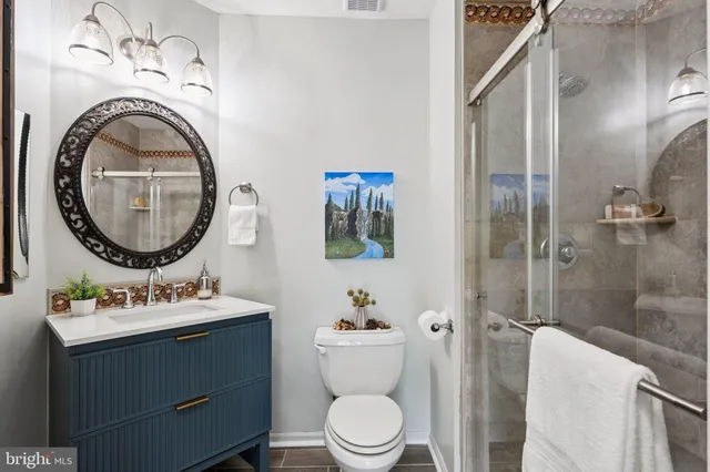 a bathroom with a toilet a sink and a mirror