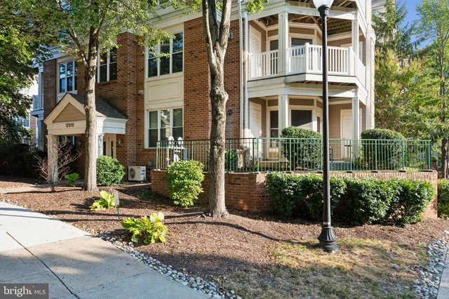 a view of a brick building next to a yard