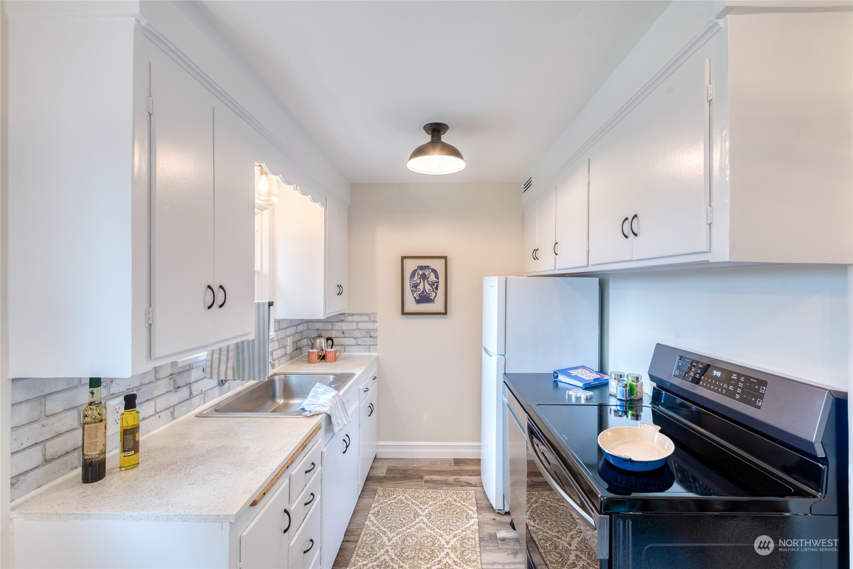 3915 Southwest Rose Street Seattle, WA 98136 - Photo 11 of 25 a kitchen with stainless steel appliances granite countertop a sink stove and cabinets