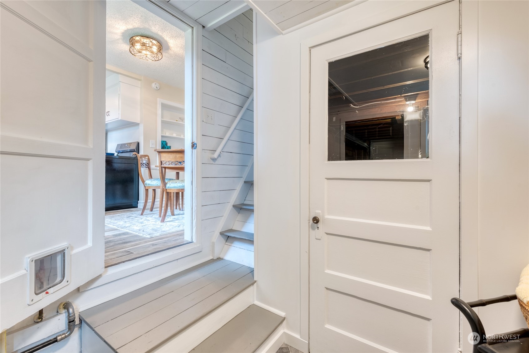 3915 Southwest Rose Street Seattle, WA 98136 - Photo 19 of 25 a view of a hallway with wooden floor and staircase