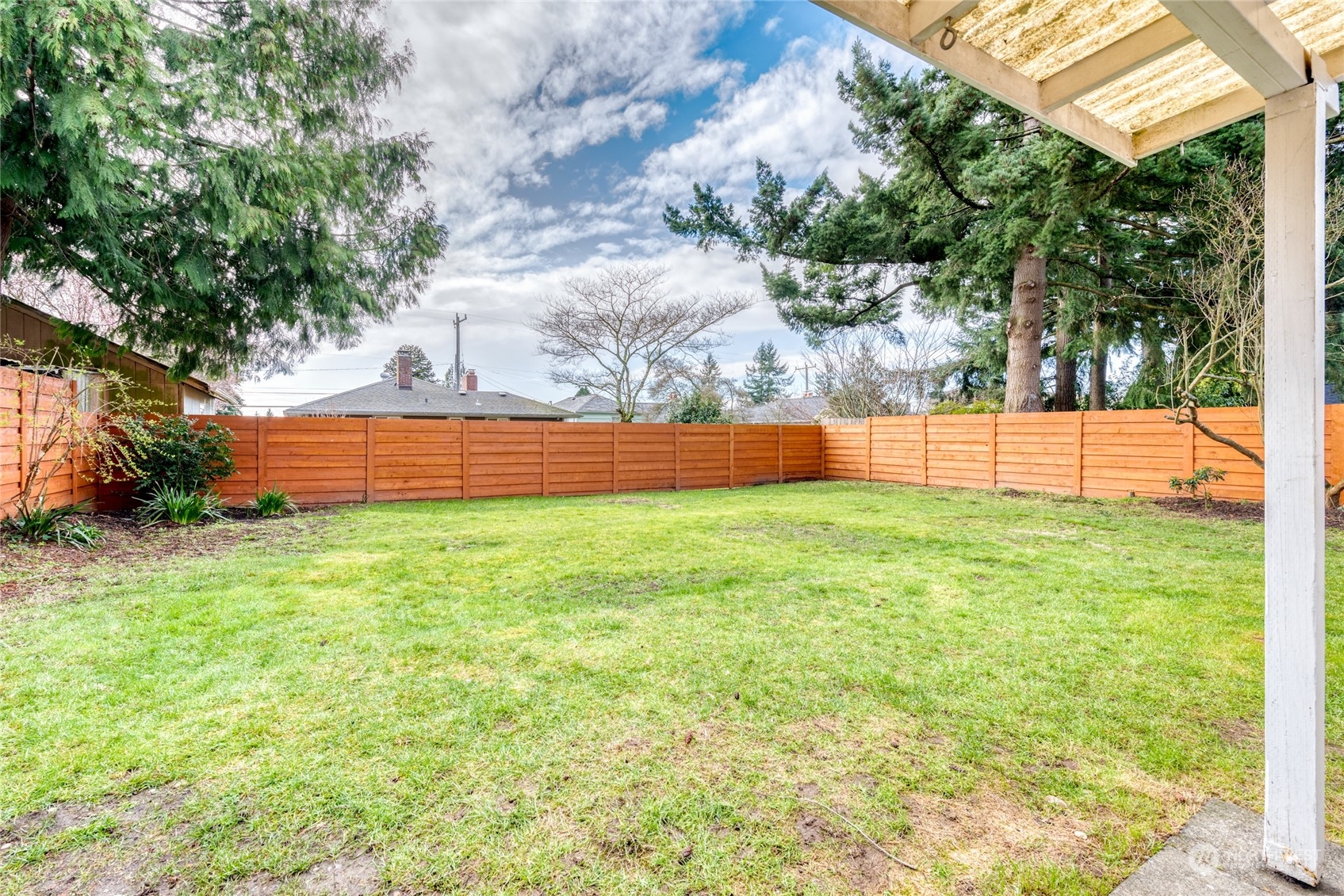3915 Southwest Rose Street Seattle, WA 98136 - Photo 22 of 25 a view of yard with grass and a fence