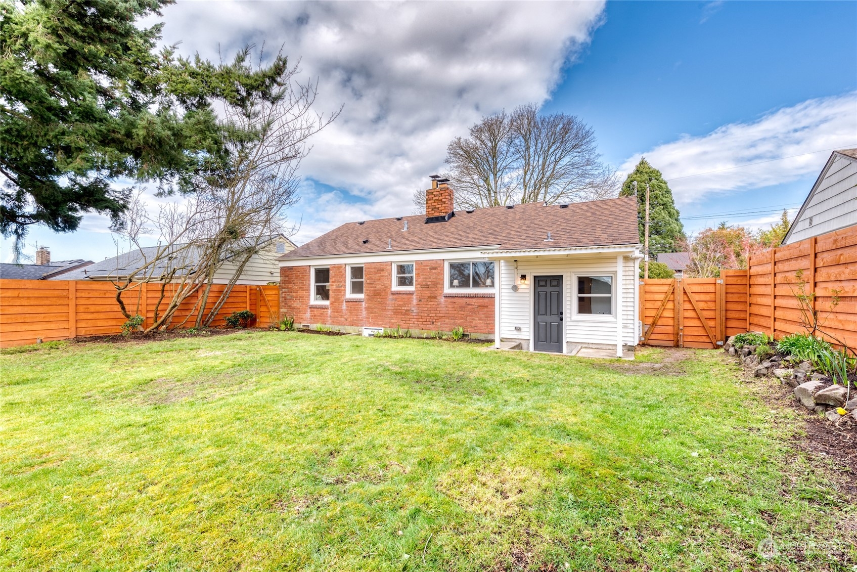 3915 Southwest Rose Street Seattle, WA 98136 - Photo 23 of 25 a front view of a house with a garden