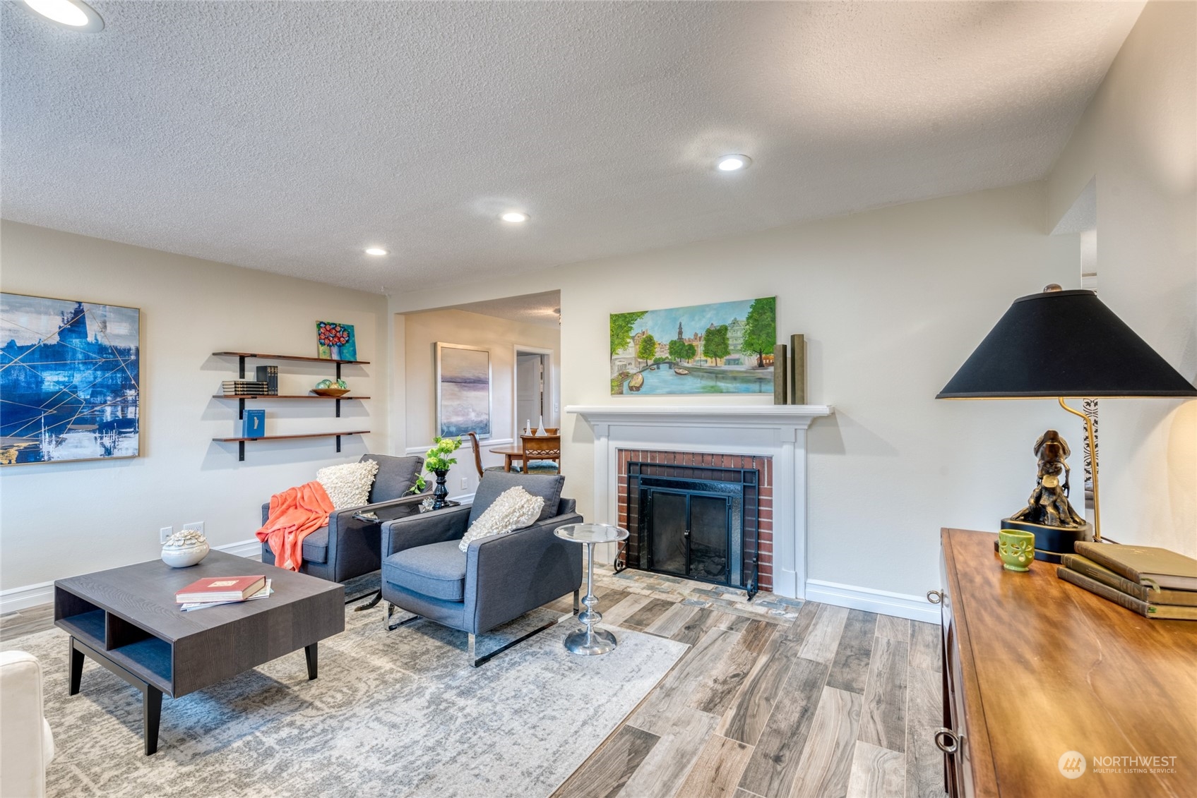 3915 Southwest Rose Street Seattle, WA 98136 - Photo 4 of 25 a living room with furniture a fireplace and a flat screen tv