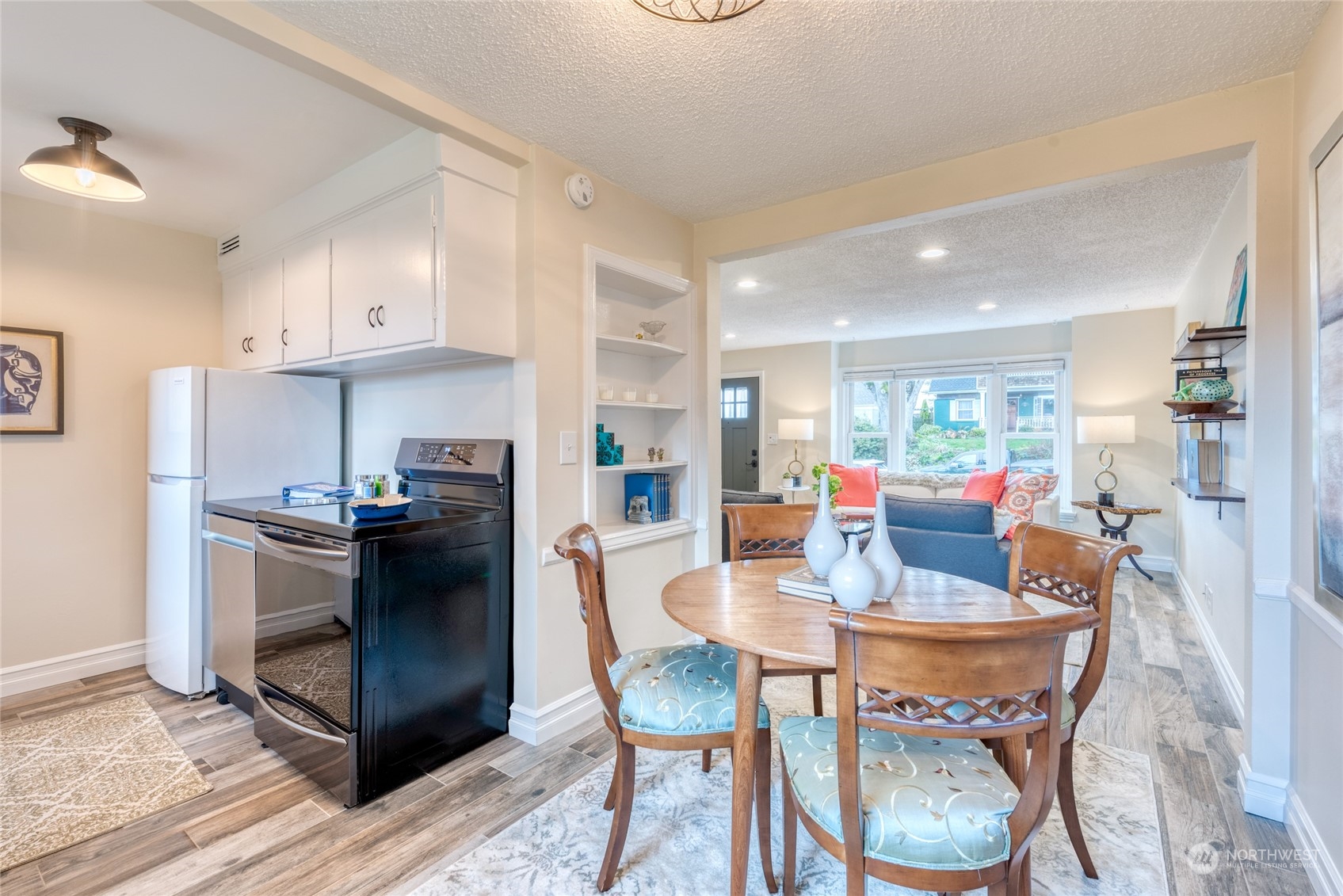 3915 Southwest Rose Street Seattle, WA 98136 - Photo 10 of 25 a kitchen with stainless steel appliances kitchen island granite countertop a table and chairs in it