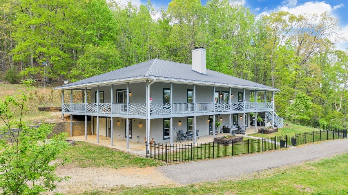 649 Greyledge Road Buchanan, VA 24066 - Photo 3 of 75 a front view of a house with a yard table and chairs