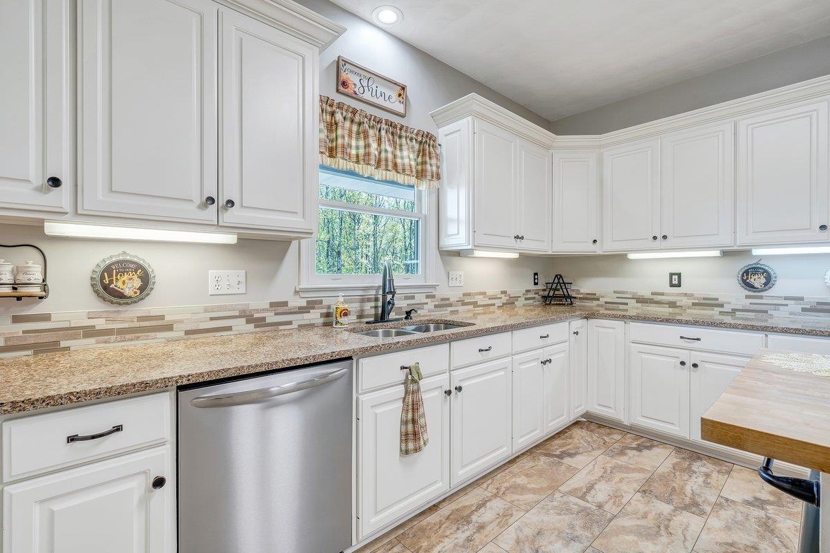 649 Greyledge Road Buchanan, VA 24066 - Photo 39 of 75 a kitchen with granite countertop white cabinets and white stainless steel appliances