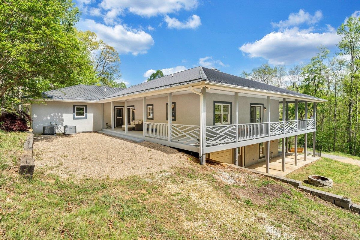 649 Greyledge Road Buchanan, VA 24066 - Photo 5 of 75 a view of a house with a wooden deck and a big yard
