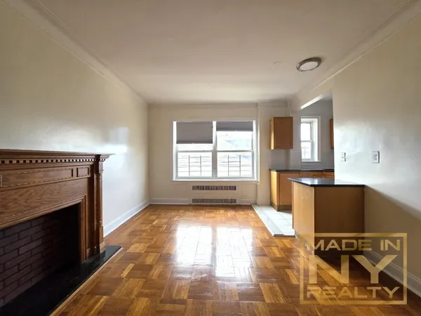 a view of an empty room with a fireplace and a window