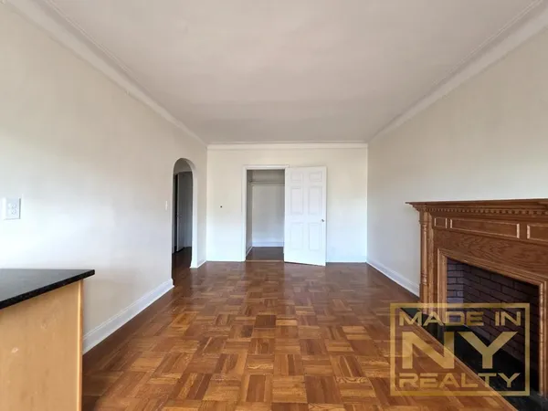 a view of a livingroom with a fireplace and a window