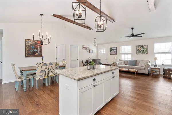a living room with furniture and kitchen view
