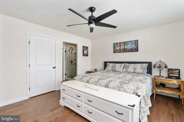 a bedroom with a bed and a ceiling fan