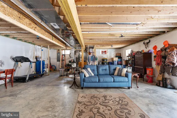 a living room with furniture and a gym