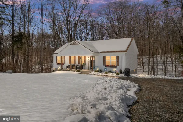 a view of a house with a yard and sitting area