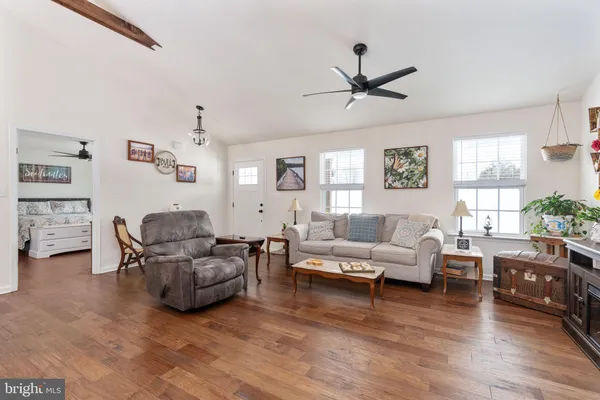 a living room with furniture and a wooden floor