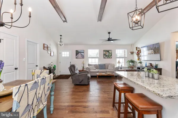 a living room with fireplace furniture and a chandelier