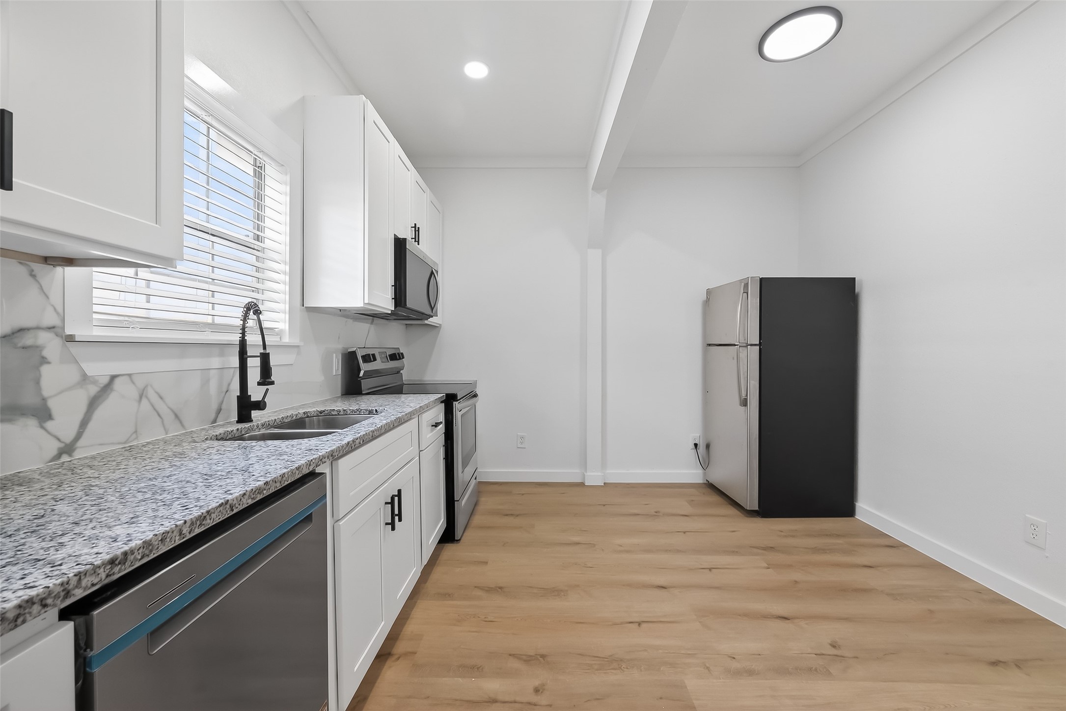 2202 Hutchins Street, Unit B Houston, TX 77003 - Photo 12 of 30 a kitchen with a sink and a refrigerator