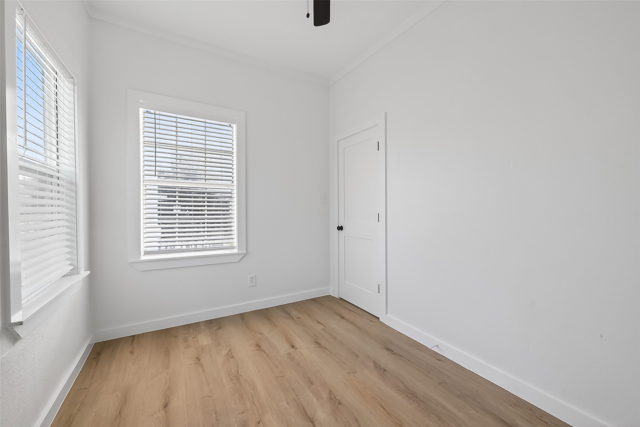 2202 Hutchins Street, Unit B Houston, TX 77003 - Photo 13 of 30 wooden floor in an empty room with a window