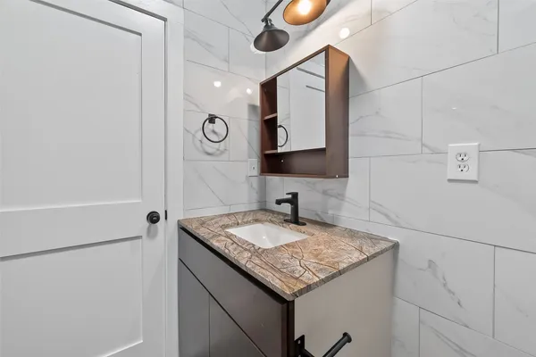 a bathroom with a toilet sink and mirror