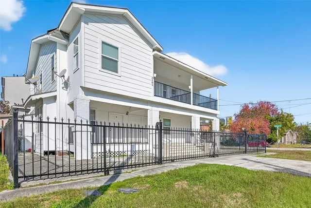 a view of a house with a yard and deck