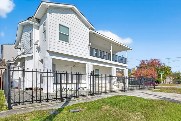 a view of a house with a yard and deck