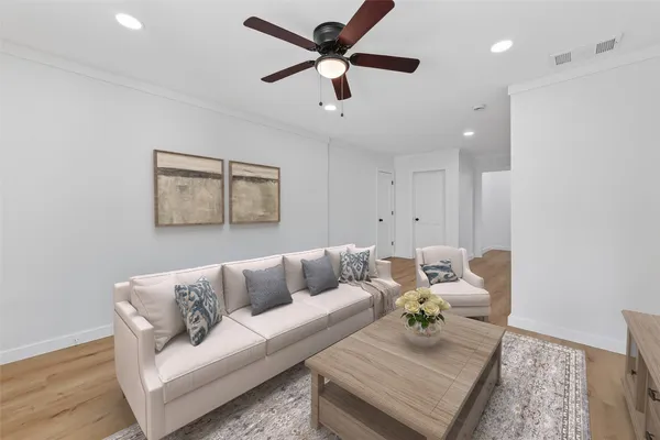 a view of empty room with wooden floor and ceiling fan