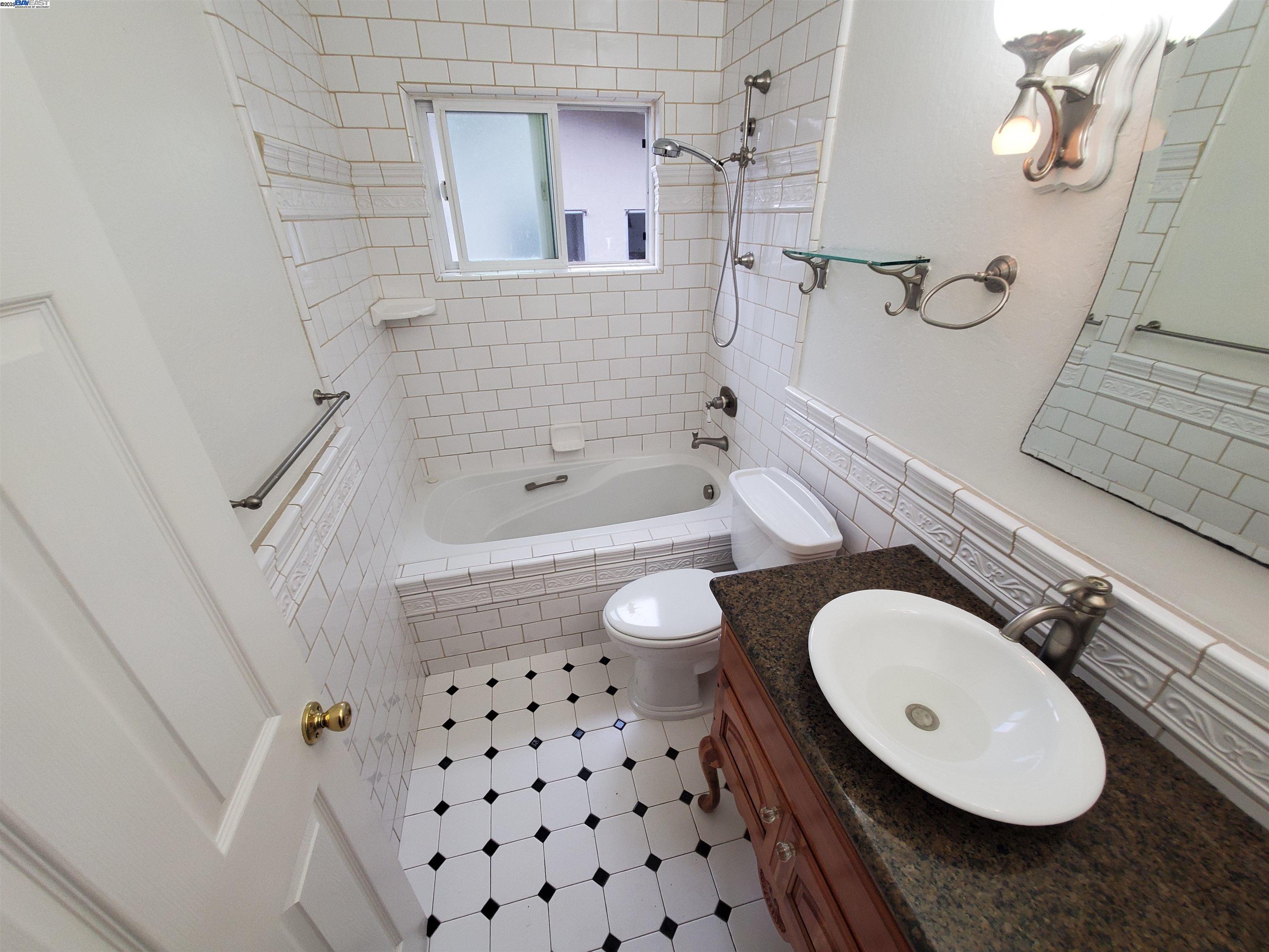 18425 Joseph Drive Castro Valley, CA 94546 - Photo 17 of 24 a bathroom with a sink a toilet a mirror a vanity and bathtub