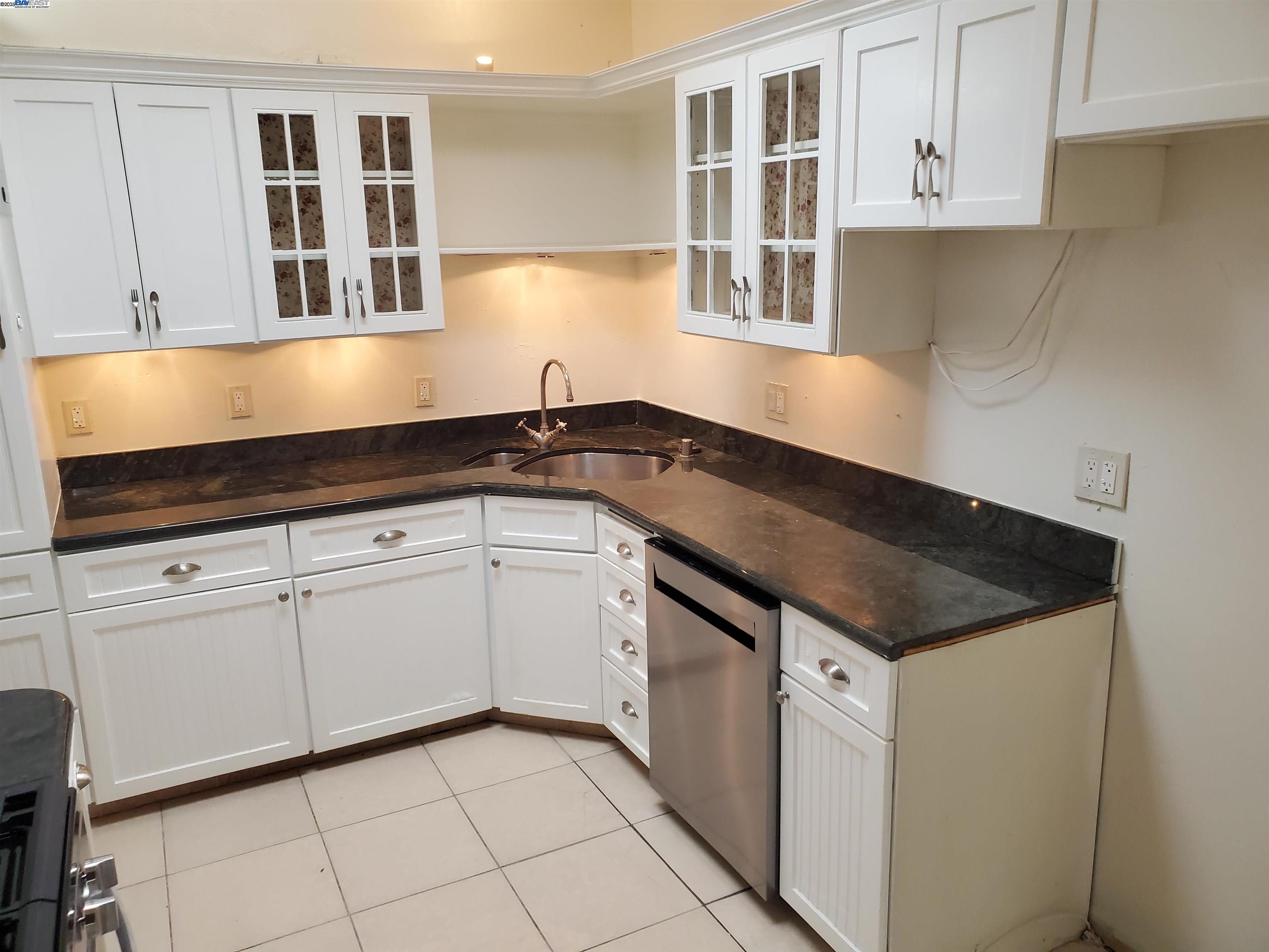 18425 Joseph Drive Castro Valley, CA 94546 - Photo 3 of 24 a kitchen with granite countertop white cabinets and sink