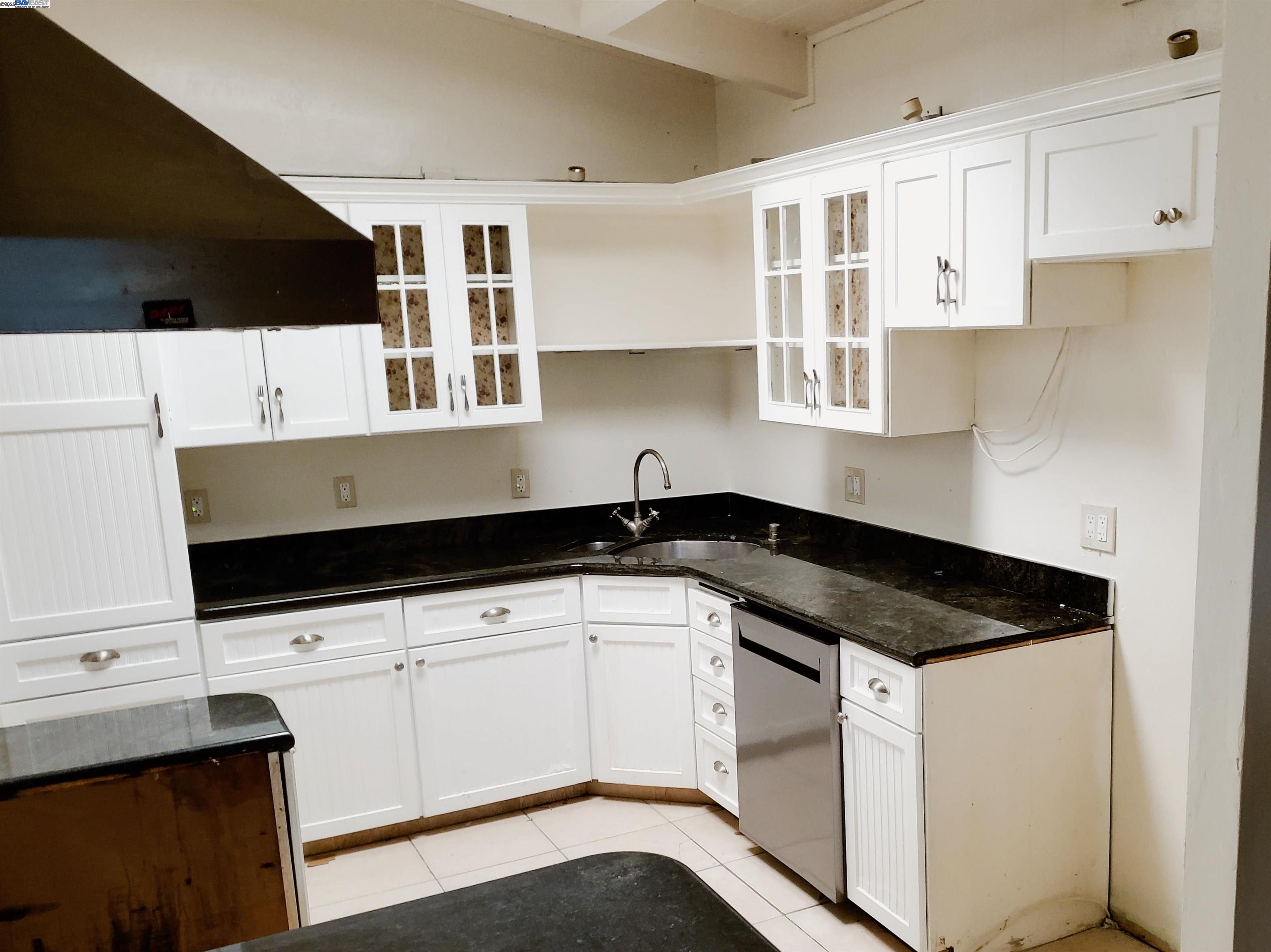 18425 Joseph Drive Castro Valley, CA 94546 - Photo 4 of 24 a kitchen with granite countertop white cabinets and a sink