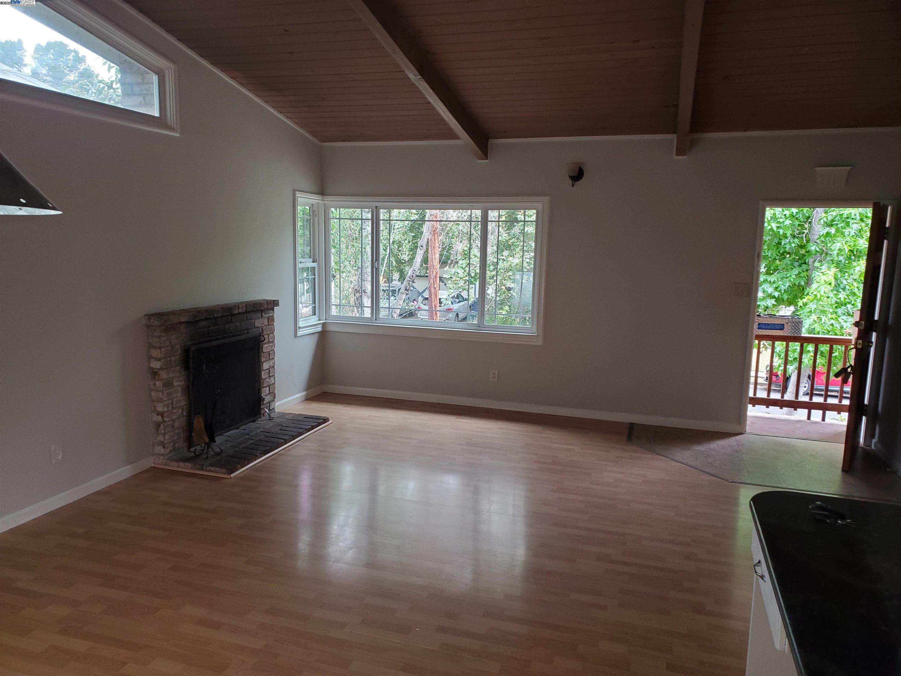 18425 Joseph Drive Castro Valley, CA 94546 - Photo 9 of 24 a view of a livingroom with wooden floor a fireplace and windows