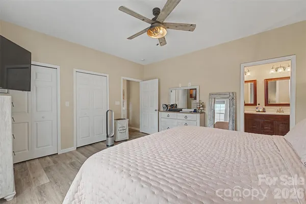 a large bedroom with a bed and a chandelier