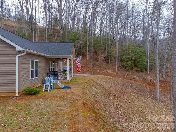 a view of a house with a yard and sitting area