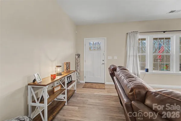 a bedroom with furniture and a large window
