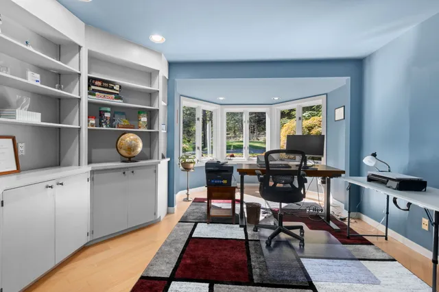 a living room with furniture a rug and a large window