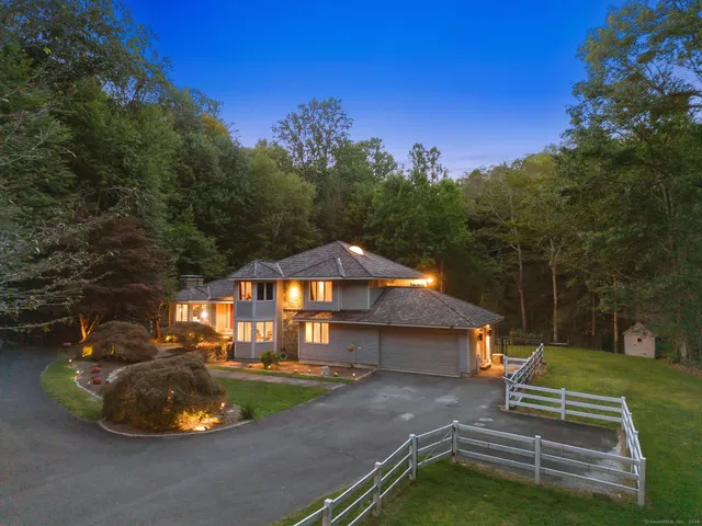 a view of a house with a yard and a garden