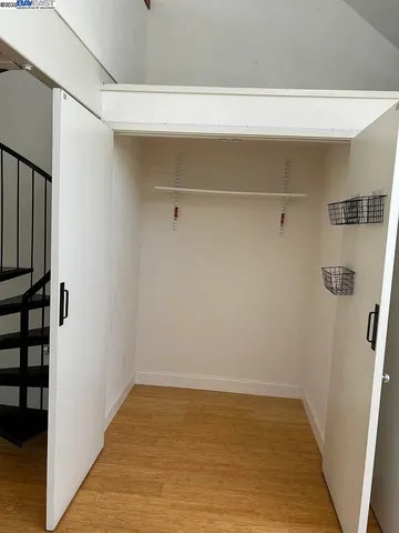 a view of a room with wooden floor and windows