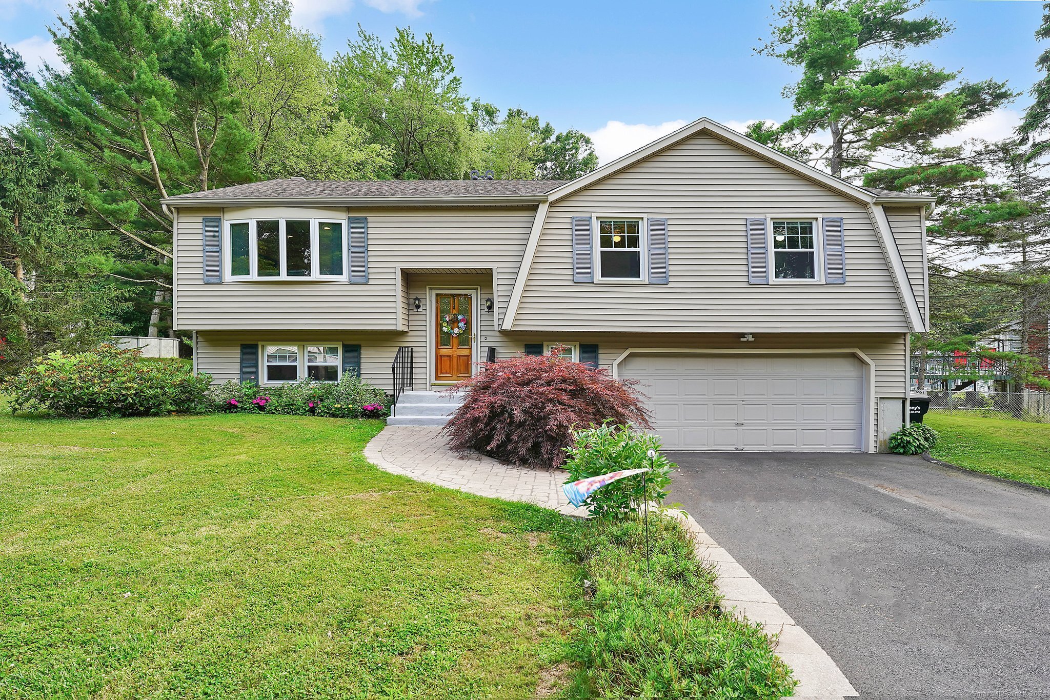 37 Schooner Lane Meriden, CT 06451 - Photo 1 of 1 a front view of a house with a garden and plants