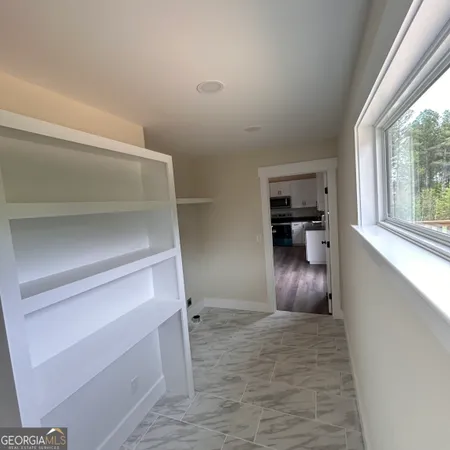 a view of an empty room with wooden floor