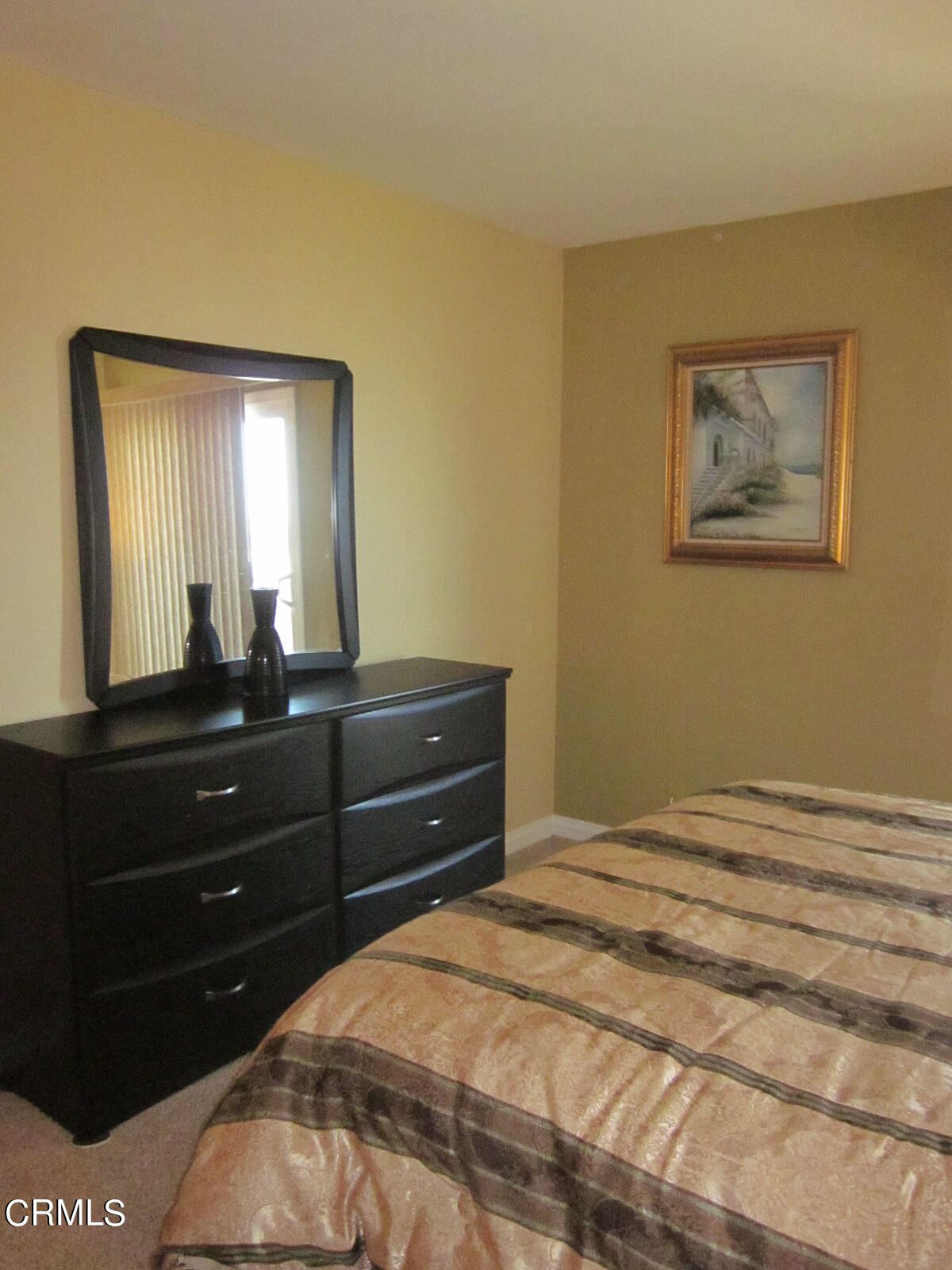 2901 Peninsula Road, Unit 242 Oxnard, CA 93035 - Photo 11 of 20 a bedroom with a bed and a mirror