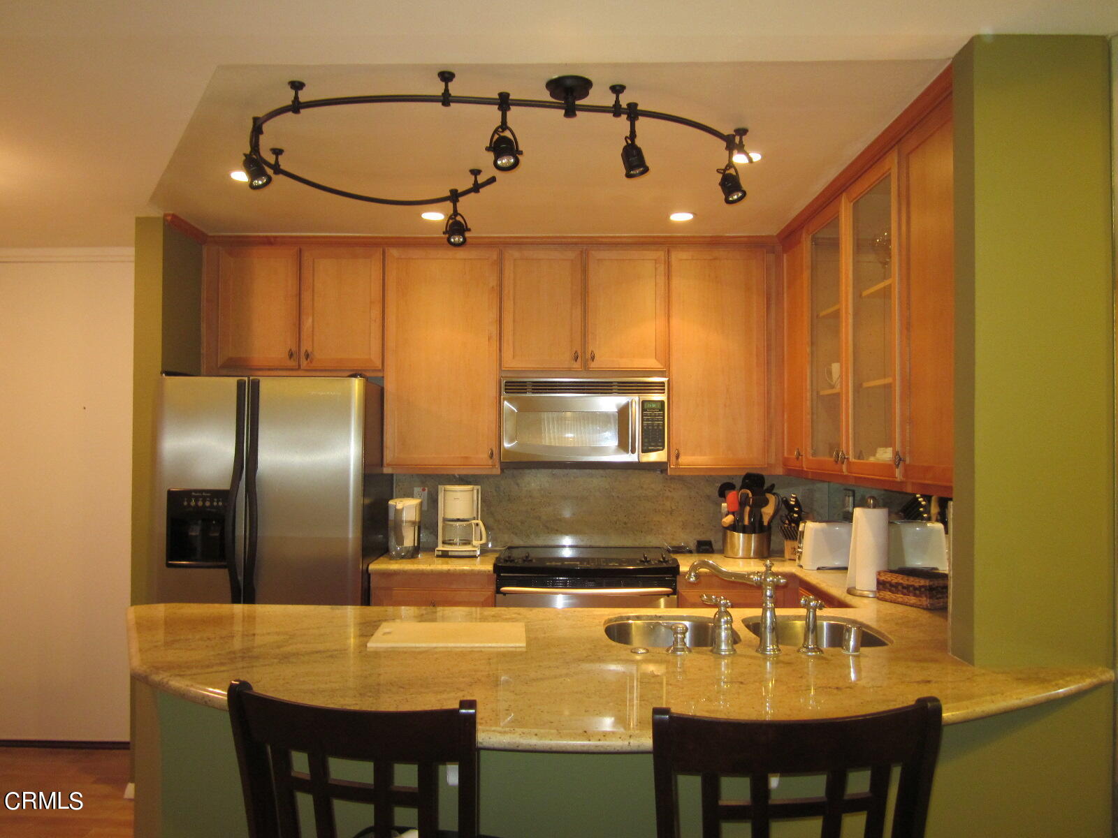 2901 Peninsula Road, Unit 242 Oxnard, CA 93035 - Photo 4 of 20 a kitchen with kitchen island a counter top space appliances and cabinets