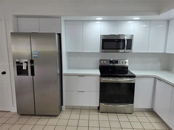 a kitchen with a stainless steel stove a refrigerator and a sink